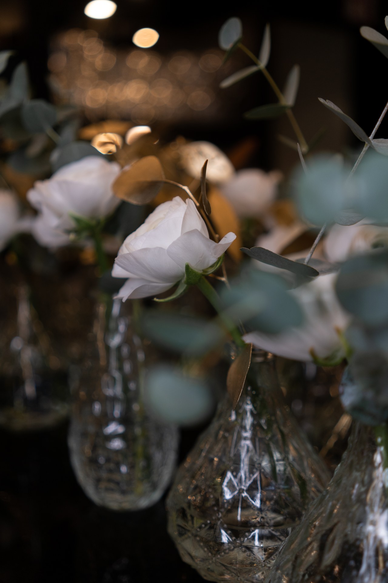 A white box with dark green ribbon on marble — rosé floral studio packaging
